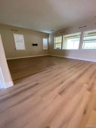 a view of wooden floor and windows in a room
