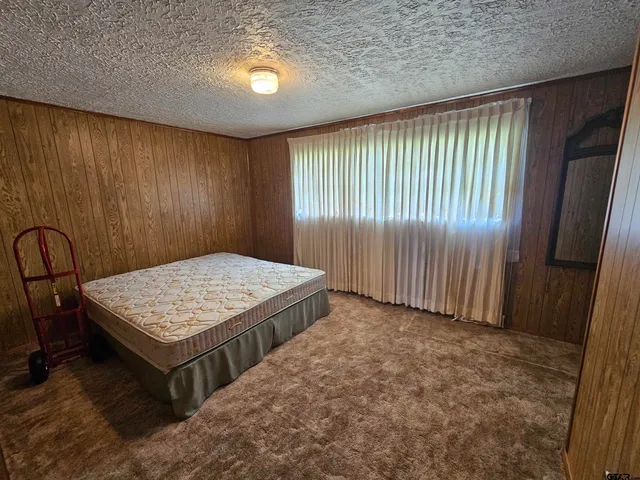 a bathroom with a granite countertop sink a mirror and vanity