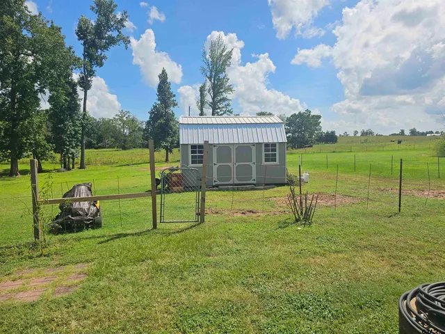 a view of a backyard with table and chairs