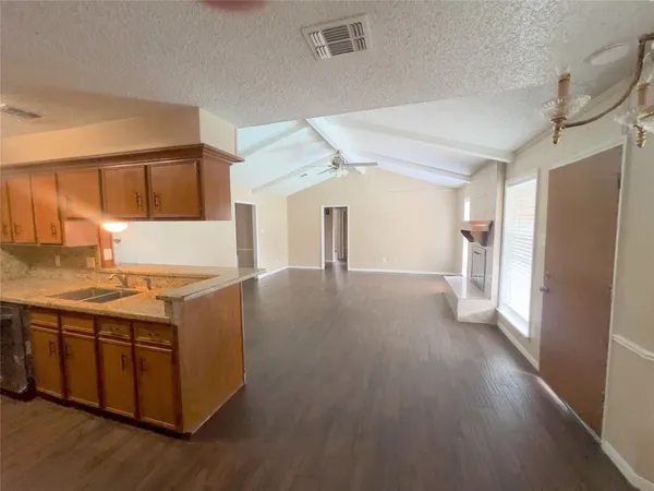 a kitchen with stainless steel appliances granite countertop a refrigerator and a stove top oven