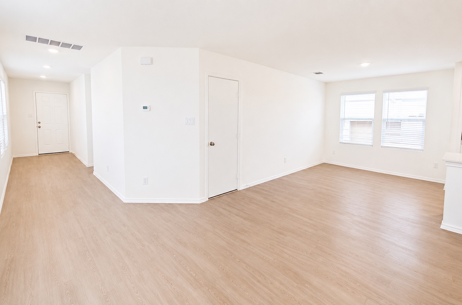 397 Keefer Kyle, TX 78640 - Photo 6 of 33 Bright, neutral-toned walls and wood-look flooring define this open-concept living space.