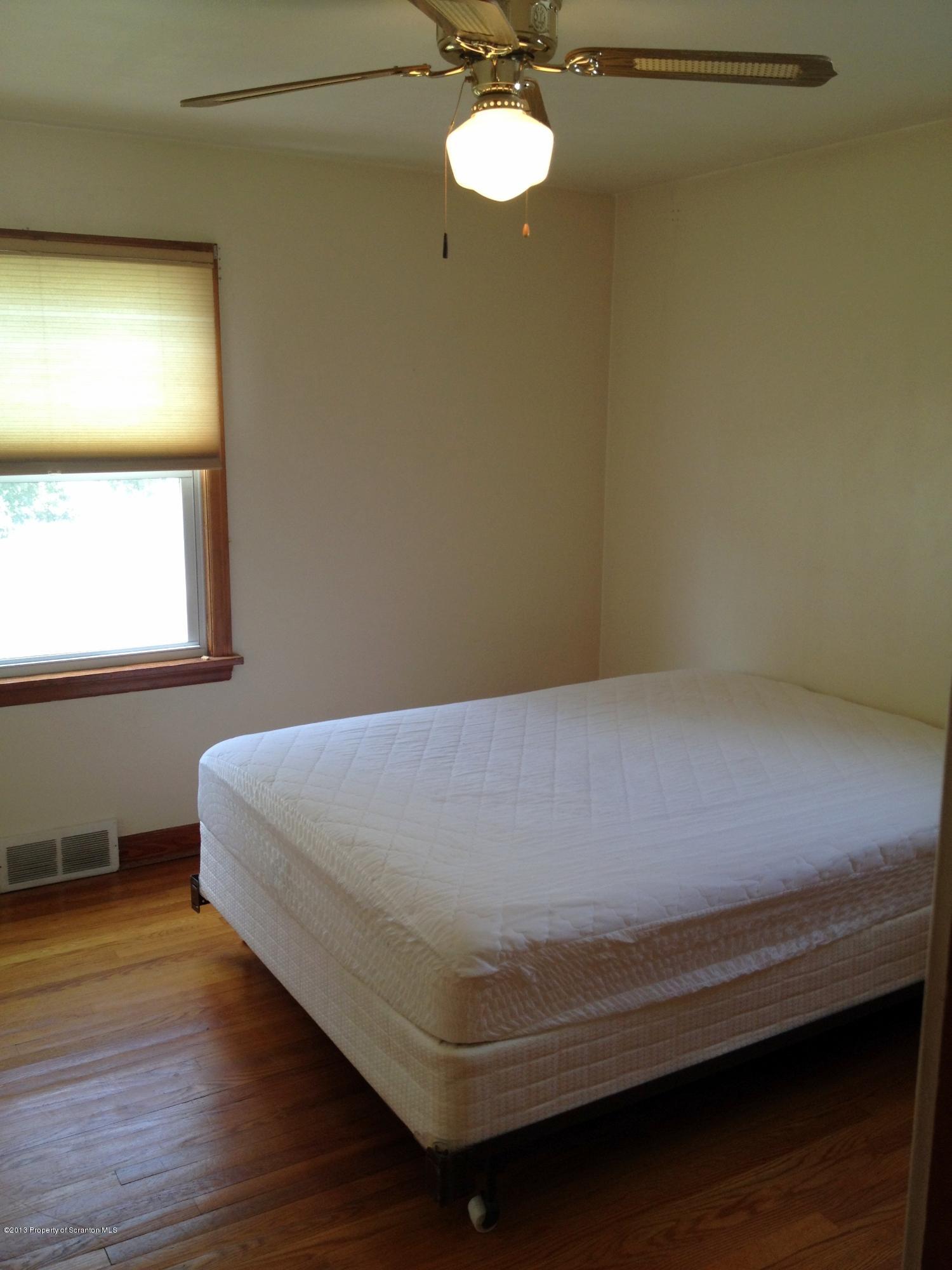 125 Corcoran Street Old Forge, PA 18518 - Photo 13 of 36 a bedroom with a bed and a window