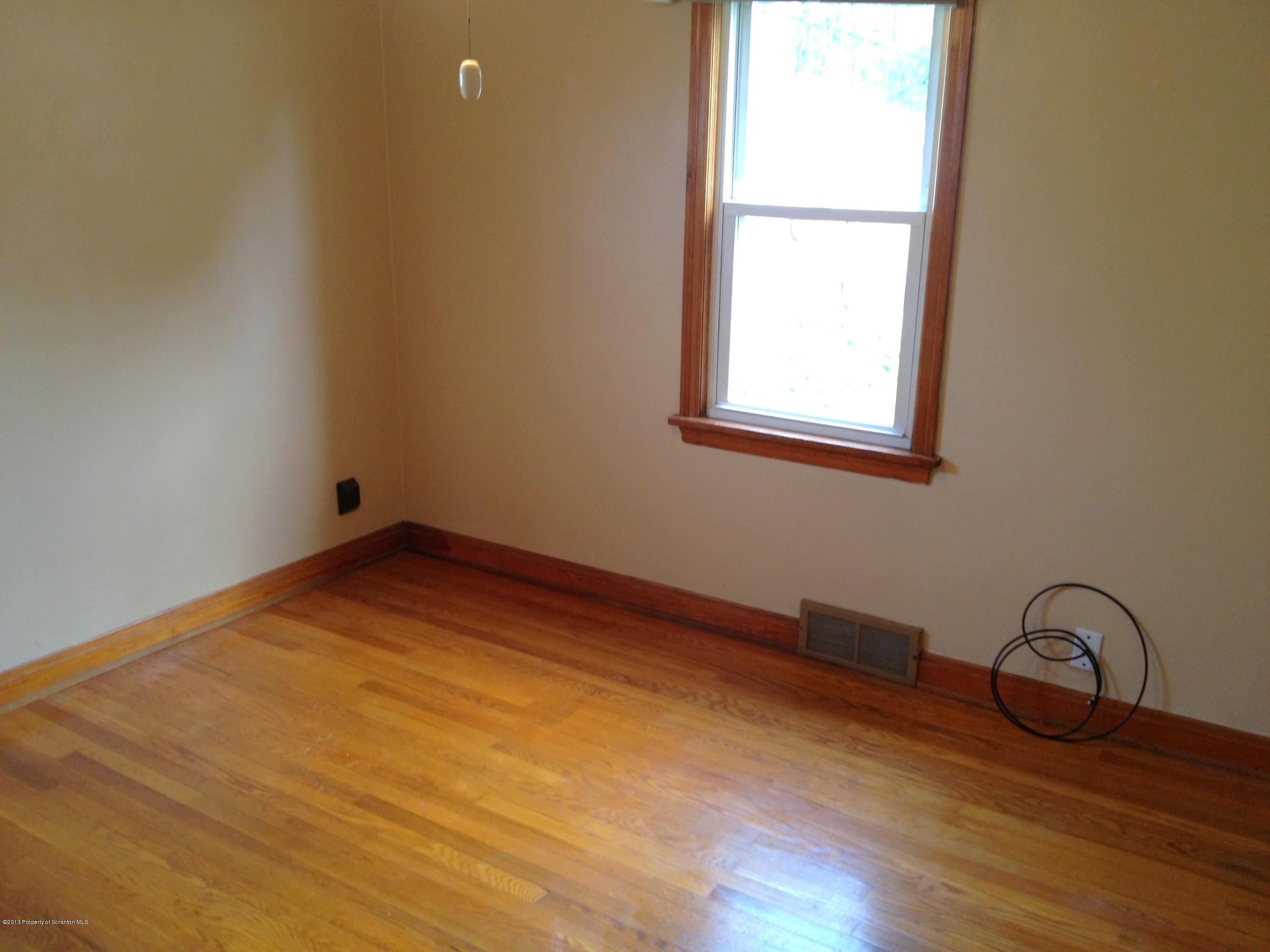 125 Corcoran Street Old Forge, PA 18518 - Photo 15 of 36 a view of a room with wooden floor and window