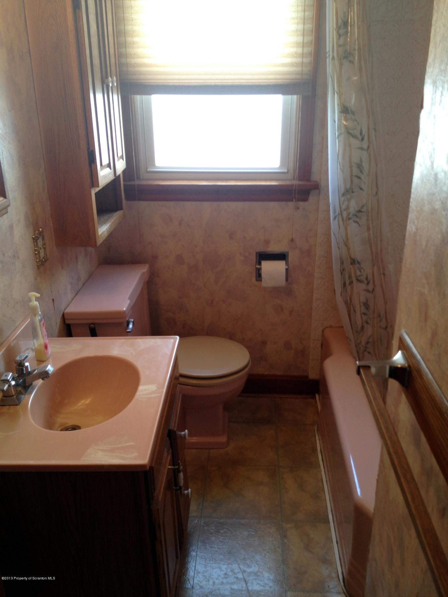 125 Corcoran Street Old Forge, PA 18518 - Photo 17 of 36 a bathroom with a sink toilet and window