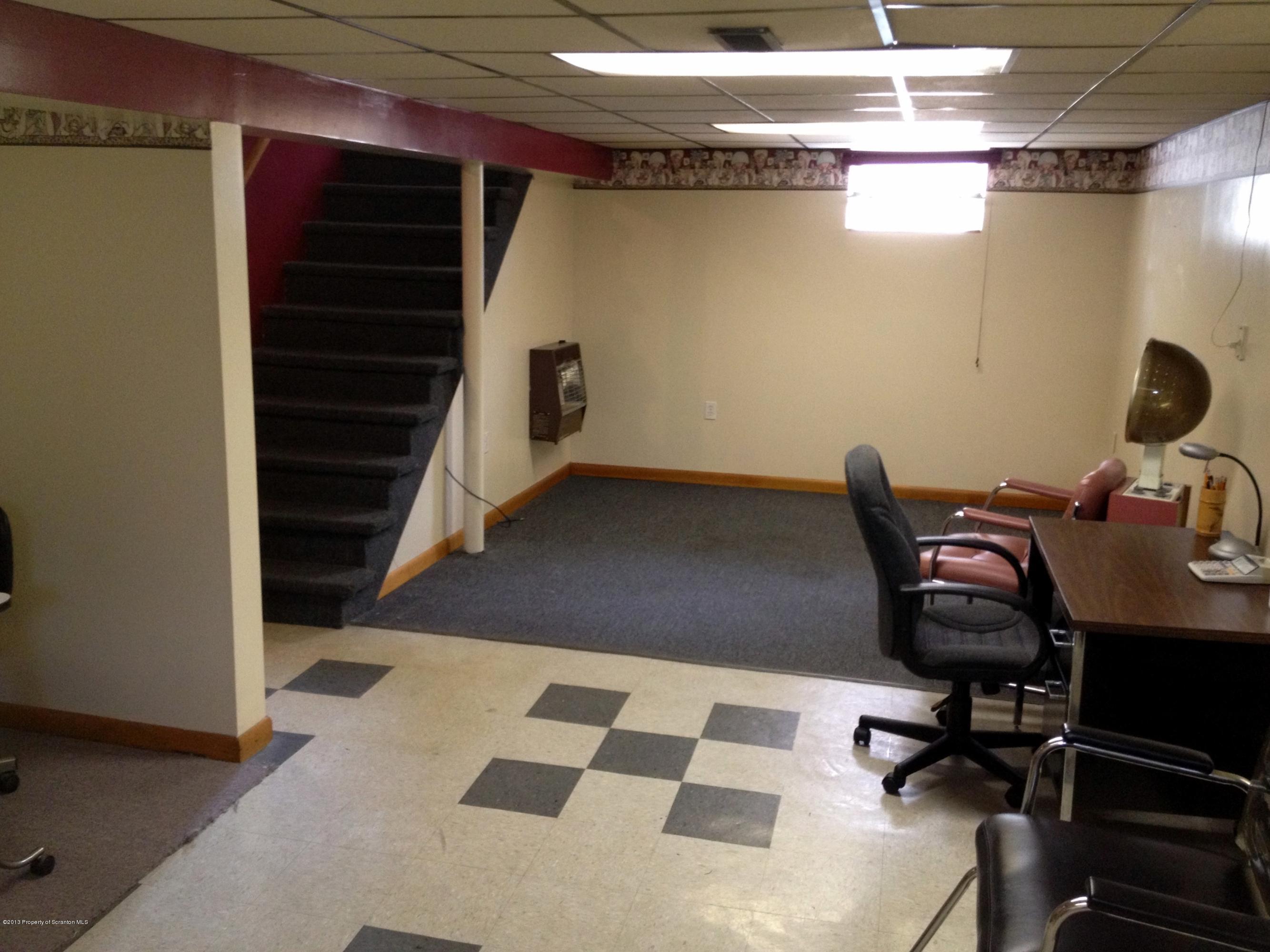 125 Corcoran Street Old Forge, PA 18518 - Photo 21 of 36 a view of a workspace with furniture and gym equipment