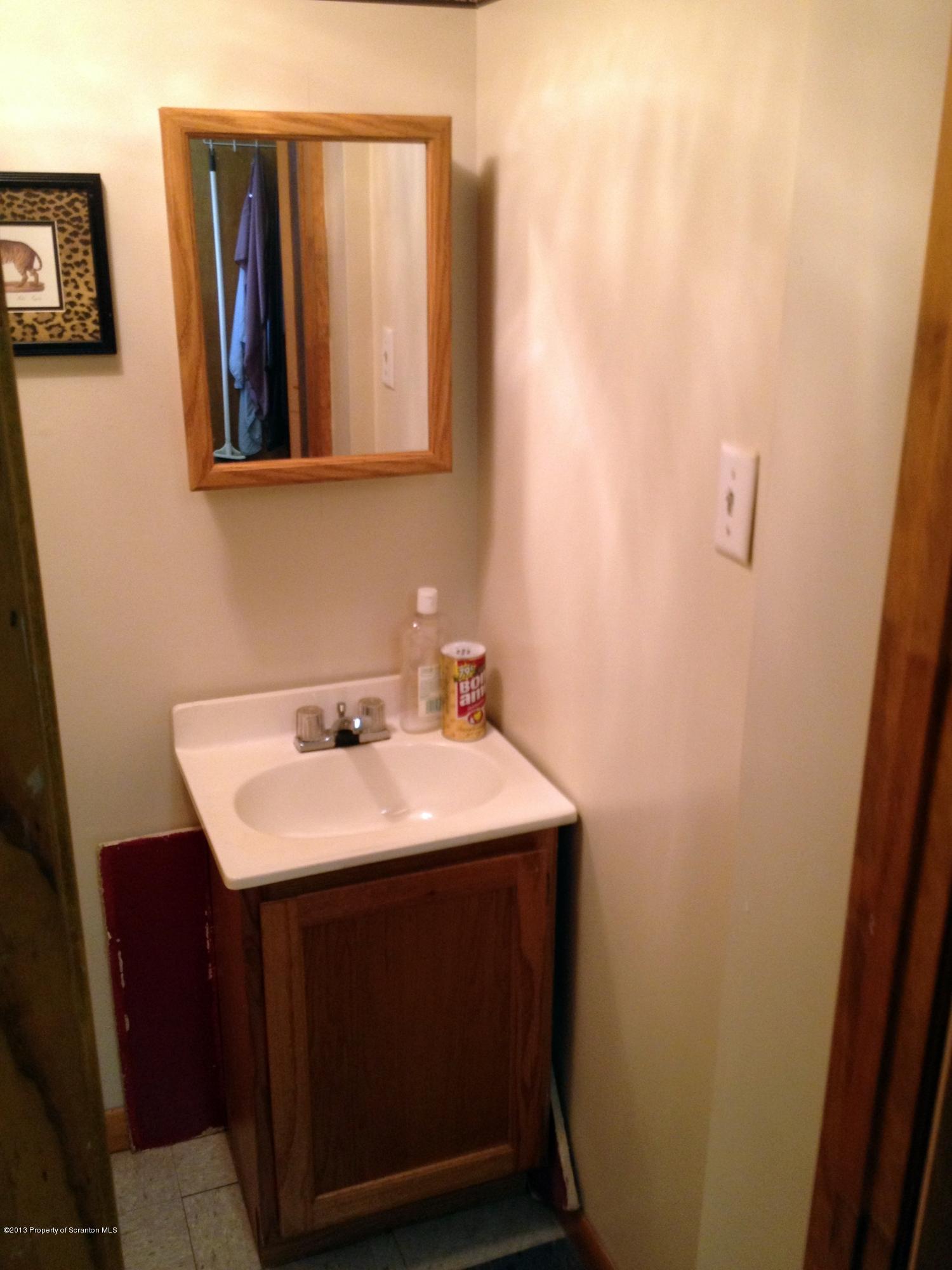 125 Corcoran Street Old Forge, PA 18518 - Photo 25 of 36 a bathroom with a sink and a mirror