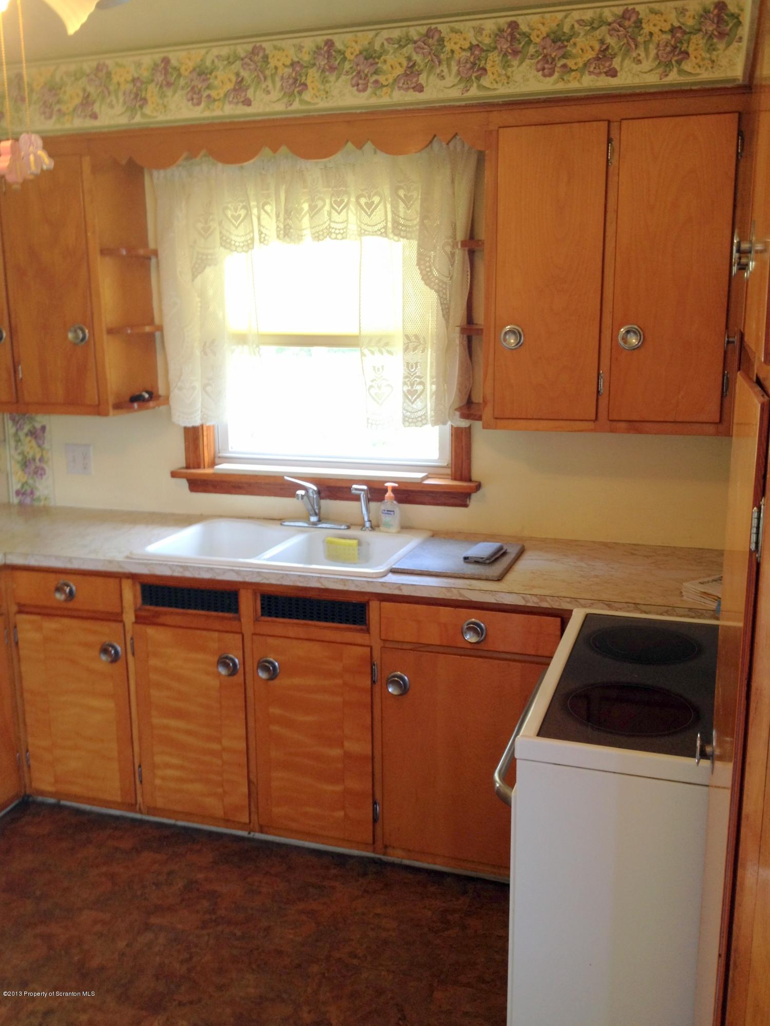 125 Corcoran Street Old Forge, PA 18518 - Photo 9 of 36 a kitchen with granite countertop a sink and a stove