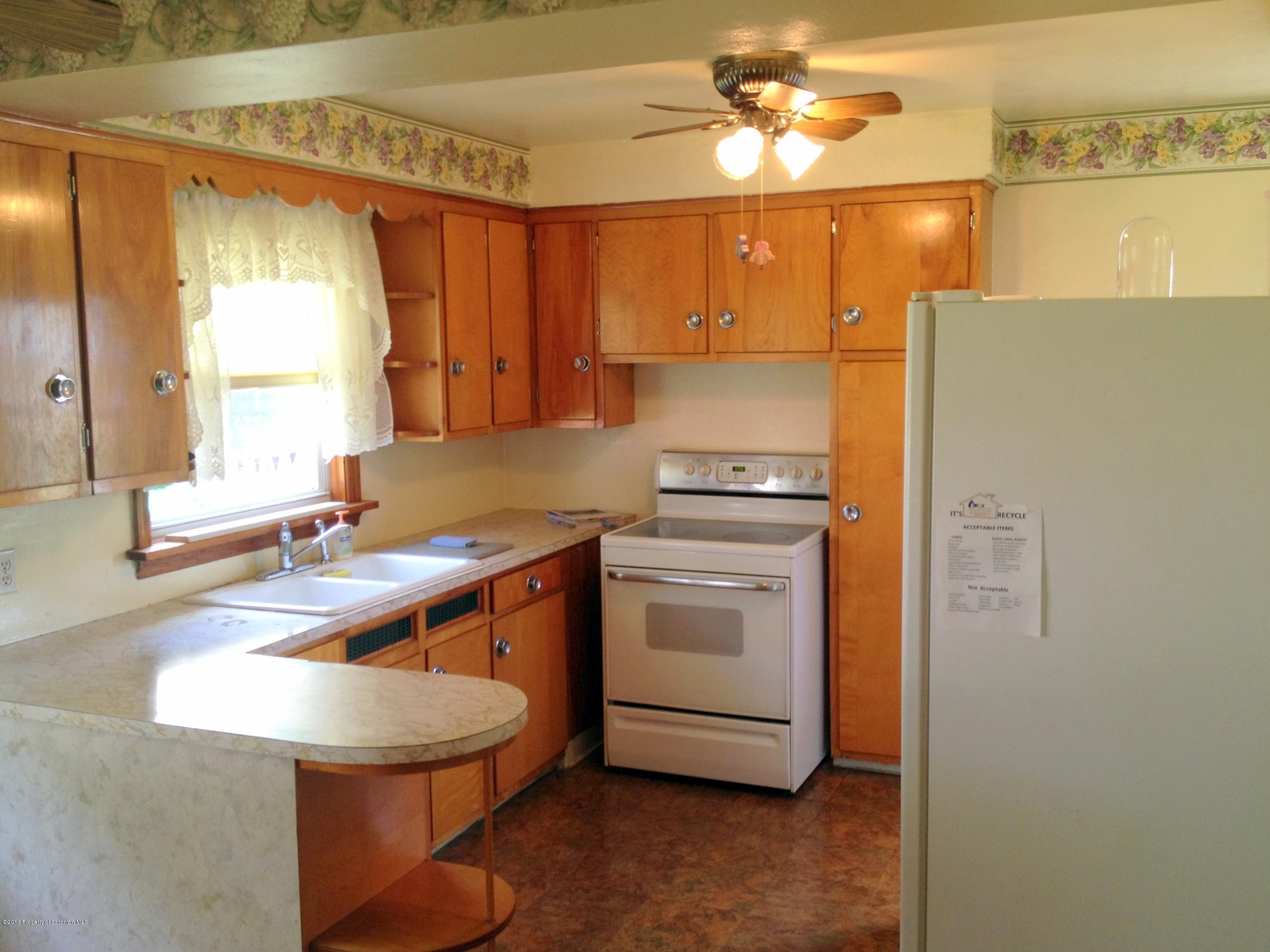 125 Corcoran Street Old Forge, PA 18518 - Photo 10 of 36 a kitchen with a sink appliances and cabinets
