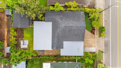 an aerial view of a house with a yard and garden