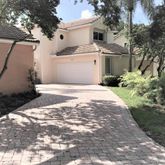 a view of a white house with a yard