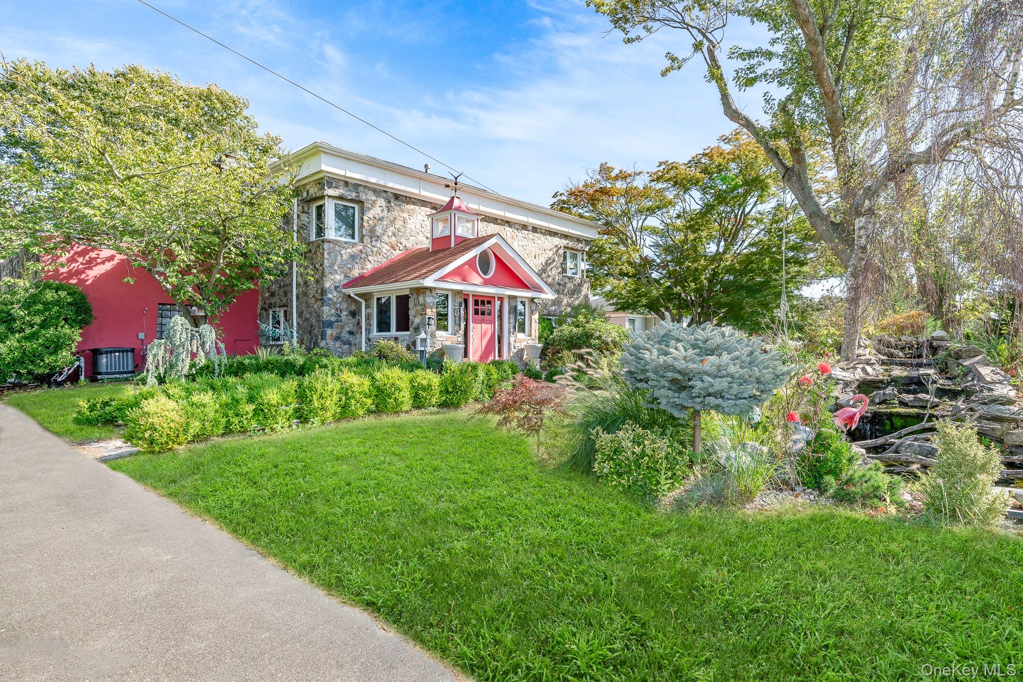 a view of a house with a yard and garden