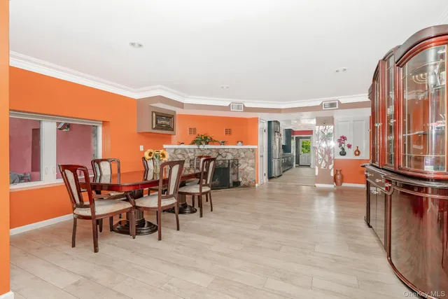 a dining room with furniture and a floor to ceiling window