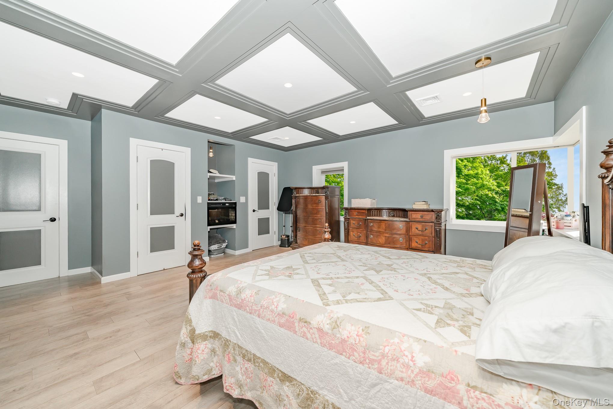 28 Riverside Avenue Amityville, NY 11701 - Photo 18 of 31 a large bedroom with wooden floor and large window