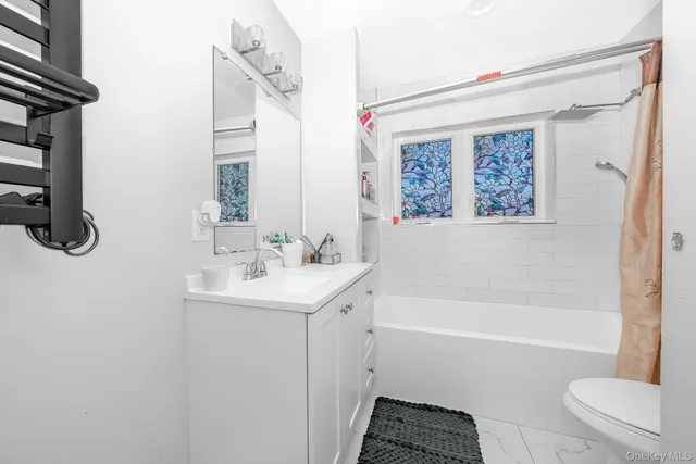 a bathroom with a sink a toilet and a bathtub