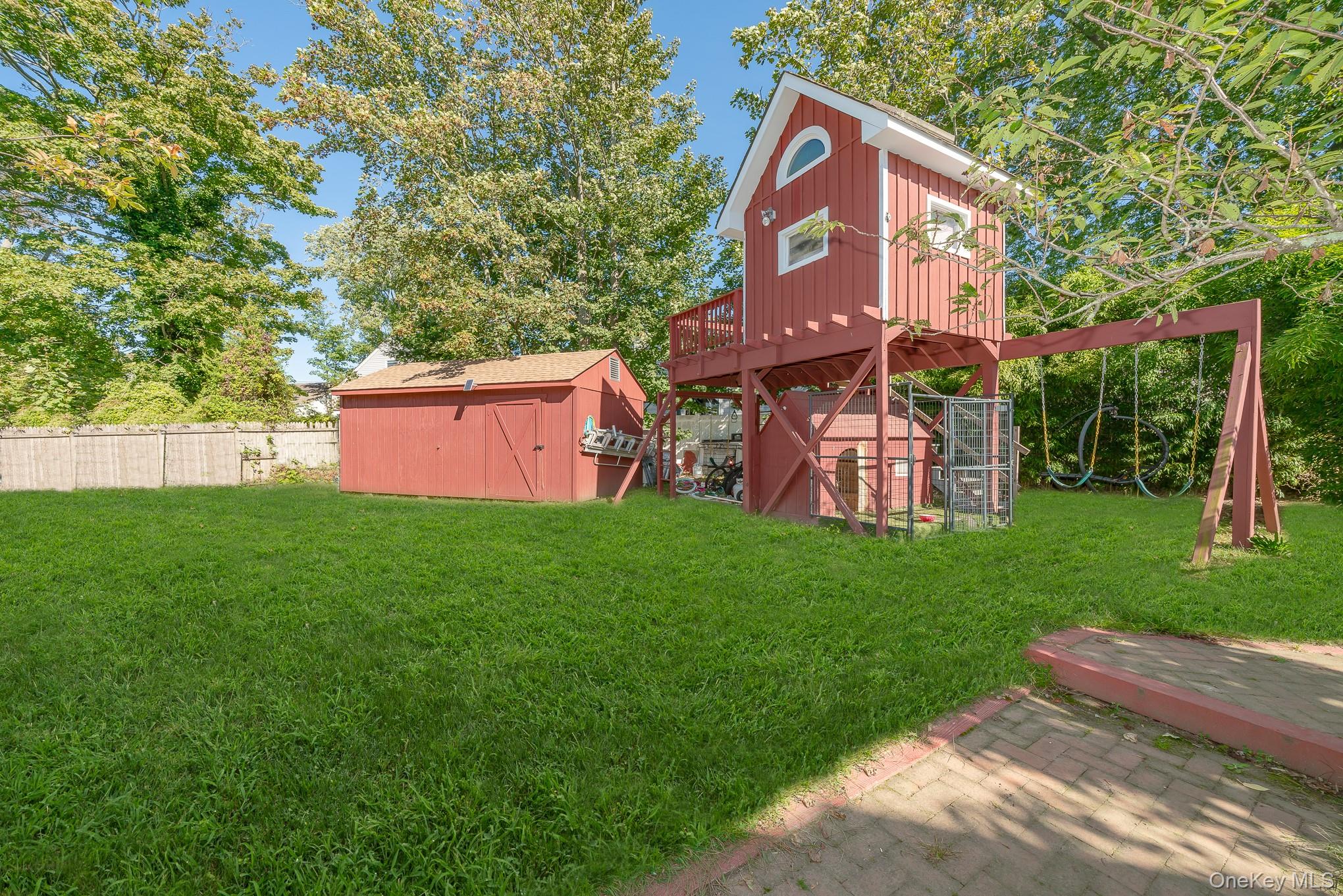 28 Riverside Avenue Amityville, NY 11701 - Photo 25 of 31 a front view of a house with a garden