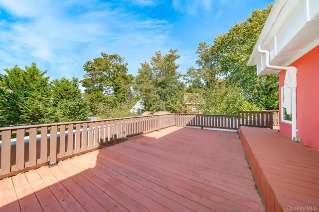 a view of balcony with wooden floor and fence