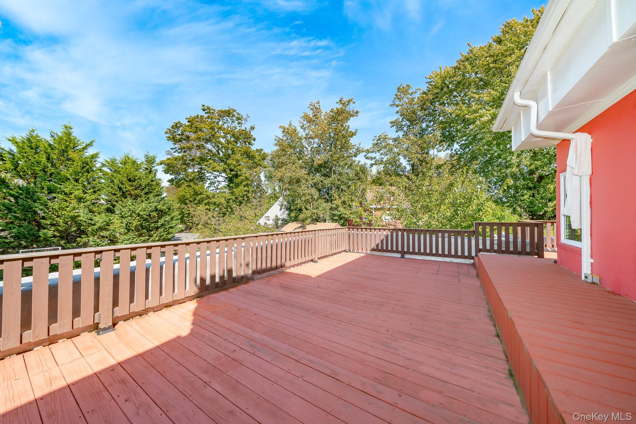 28 Riverside Avenue Amityville, NY 11701 - Photo 27 of 31 a view of balcony with wooden floor and fence