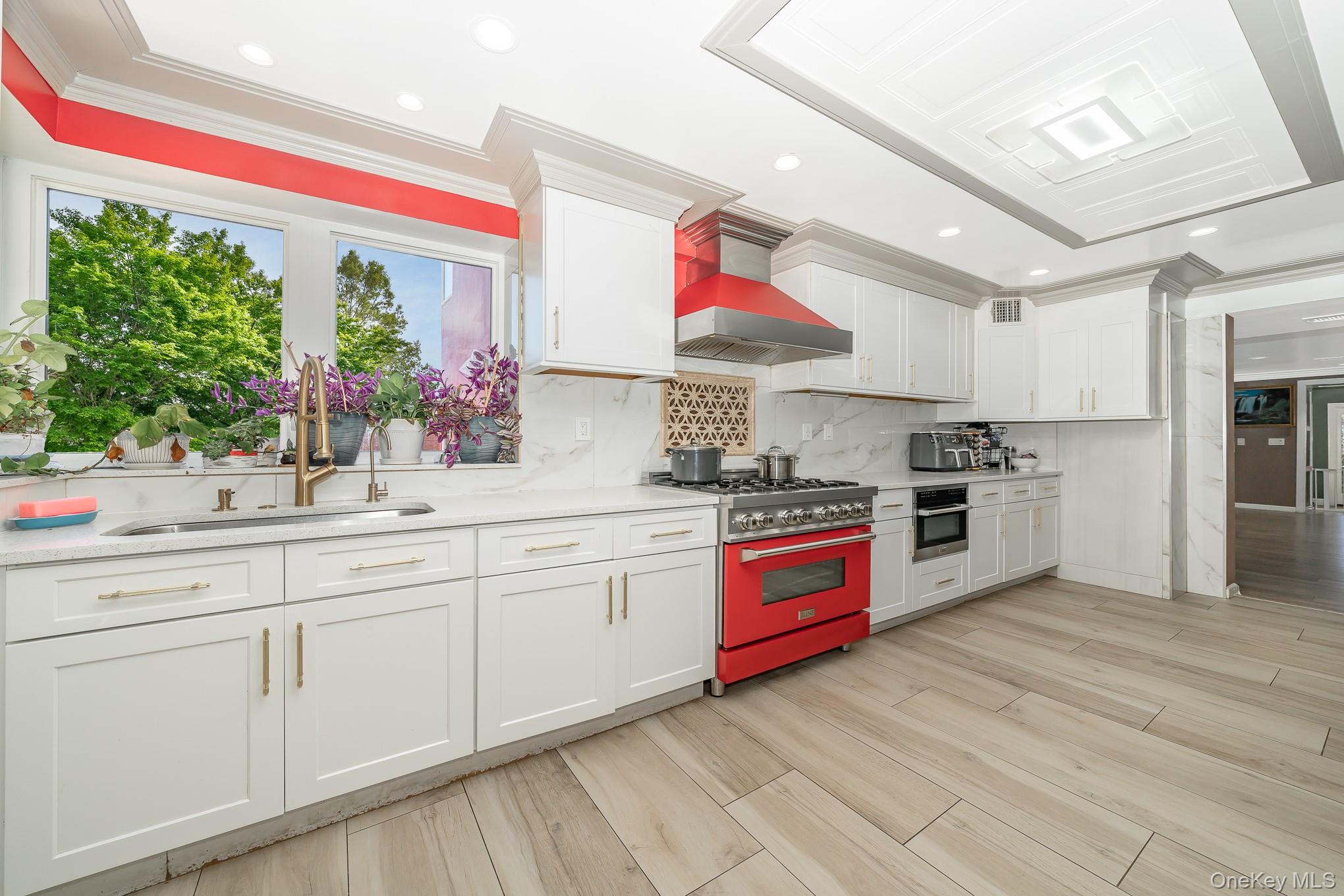 28 Riverside Avenue Amityville, NY 11701 - Photo 7 of 31 a kitchen with stainless steel appliances granite countertop a stove a sink and a refrigerator