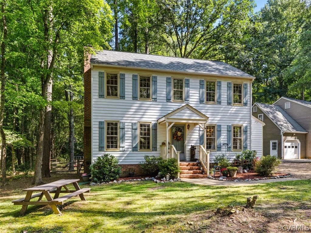 13916 Sterlings Bridge Road Midlothian, VA 23112 - Photo 3 of 36 a front view of a house with a garden and swimming pool