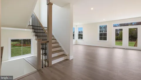 a view of a livingroom with wooden floor and white walls