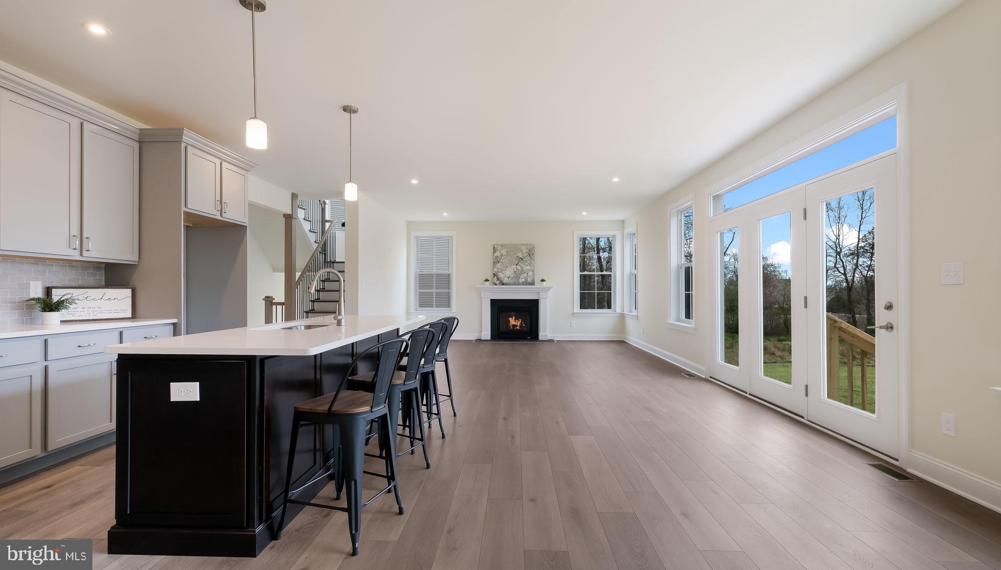 321 Green Top Road, Unit 7 Quakertown, PA 18951 - Photo 17 of 41 a kitchen with stainless steel appliances granite countertop a refrigerator a sink dishwasher a stove and a dining table with wooden floor