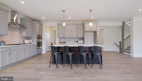 a large kitchen with a table and chairs
