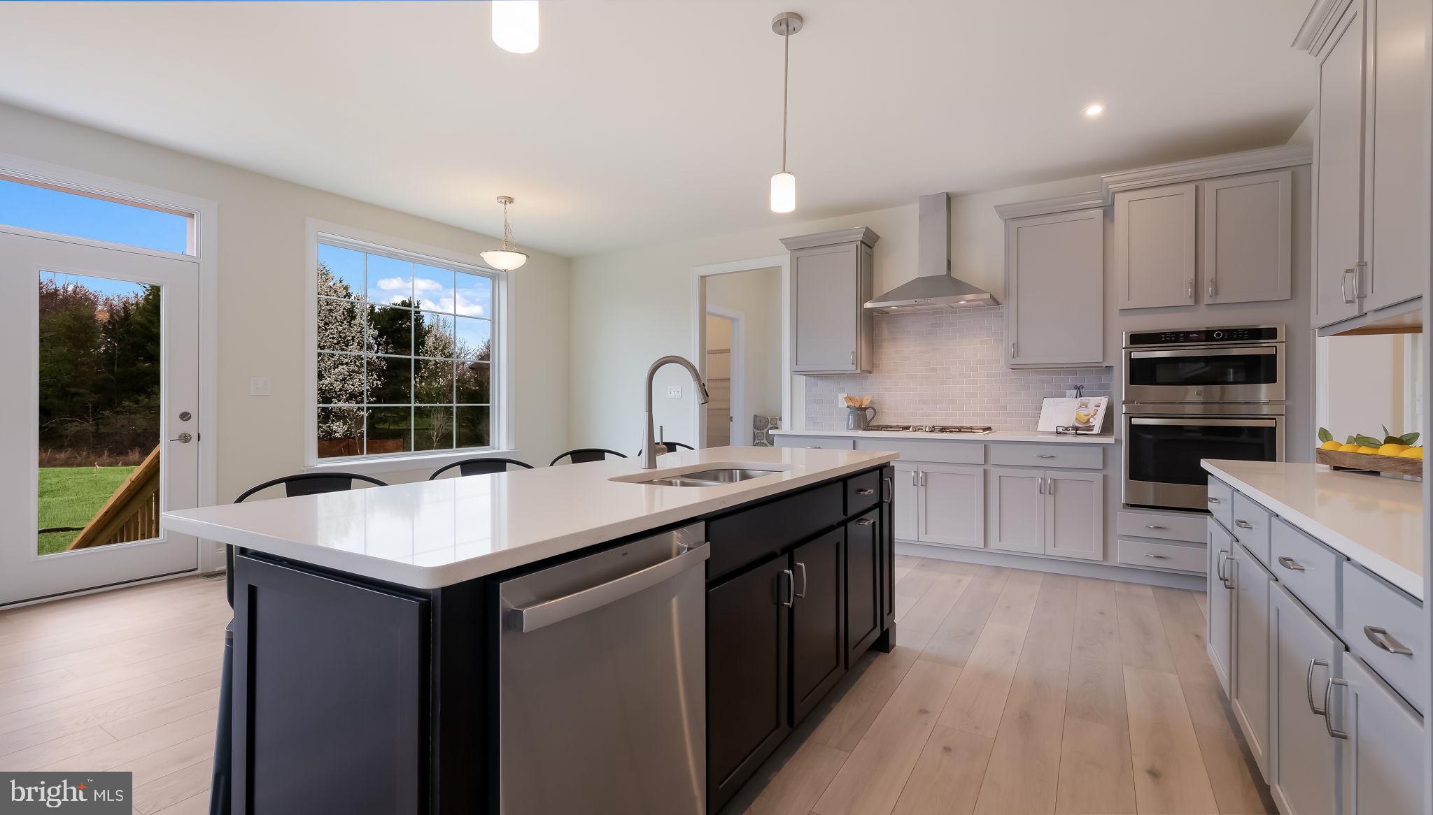 321 Green Top Road, Unit 7 Quakertown, PA 18951 - Photo 20 of 41 a kitchen with kitchen island granite countertop a sink appliances cabinets and a counter top space