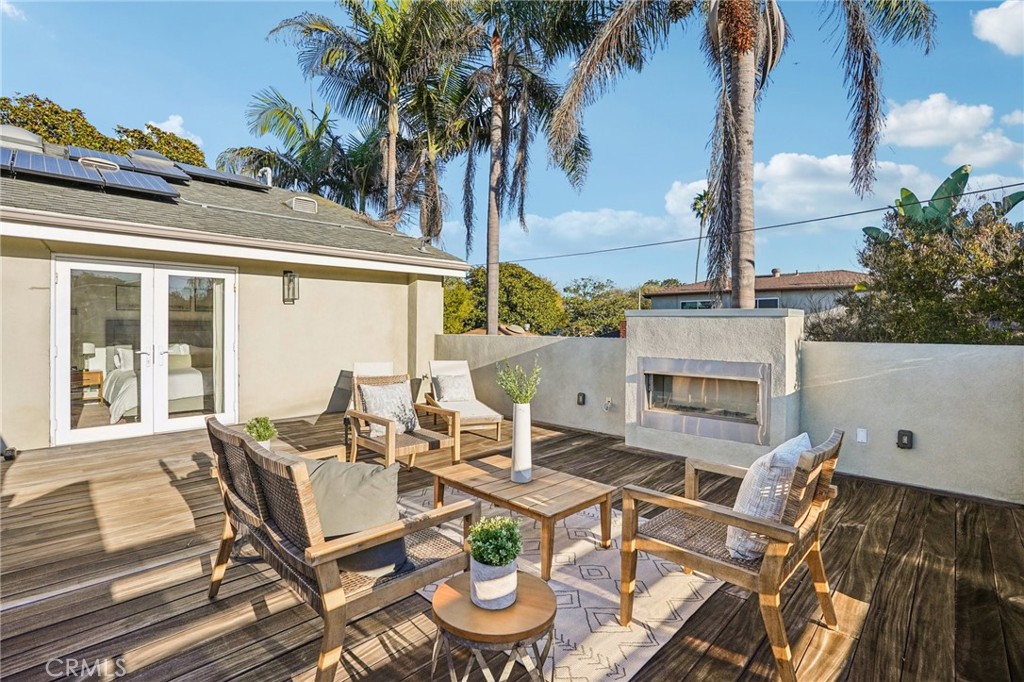 1237 South Gertruda Avenue Redondo Beach, CA 90277 - Photo 38 of 52 a view of a patio with table and chairs potted plants and palm tree