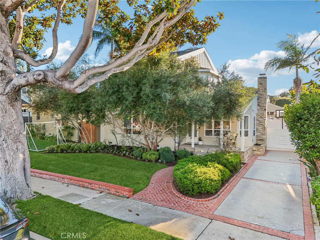 1237 South Gertruda Avenue Redondo Beach, CA 90277 - Photo 46 of 52 a front view of a house with a yard and potted plants
