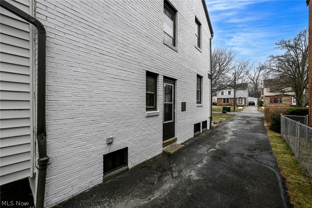 3699 Bainbridge Road Cleveland Heights, OH 44118 - Photo 4 of 37 White painted brick exterior with black framed windows and a side entry door