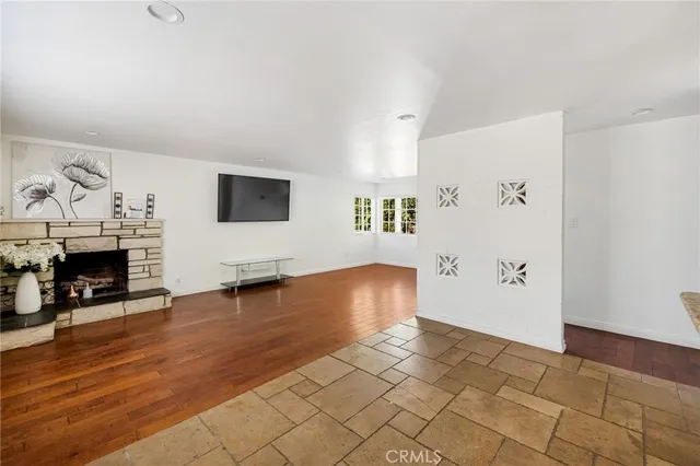 a view of a livingroom with a fireplace and window