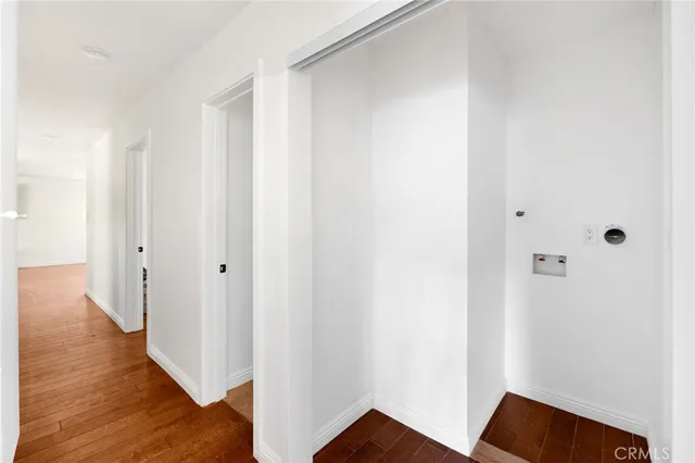 a view of hallway with wooden floor