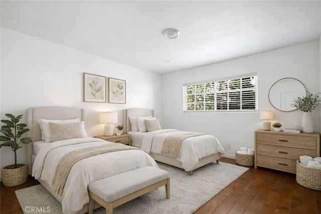 a bedroom with two bed and a dresser