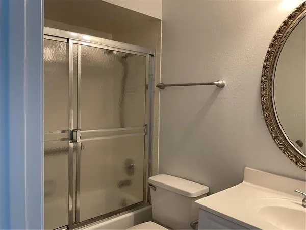 a bathroom with a shower and a toilet