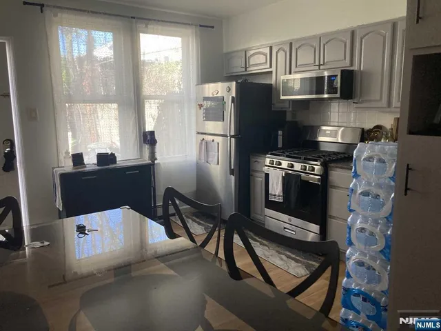 a kitchen with stainless steel appliances a stove a refrigerator and a refrigerator