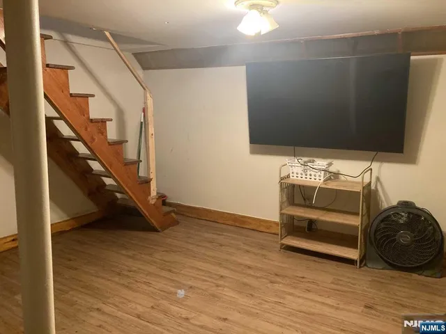 a view of an empty room with stairs and furniture