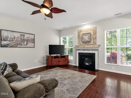 a living room with furniture a flat screen tv and a fireplace