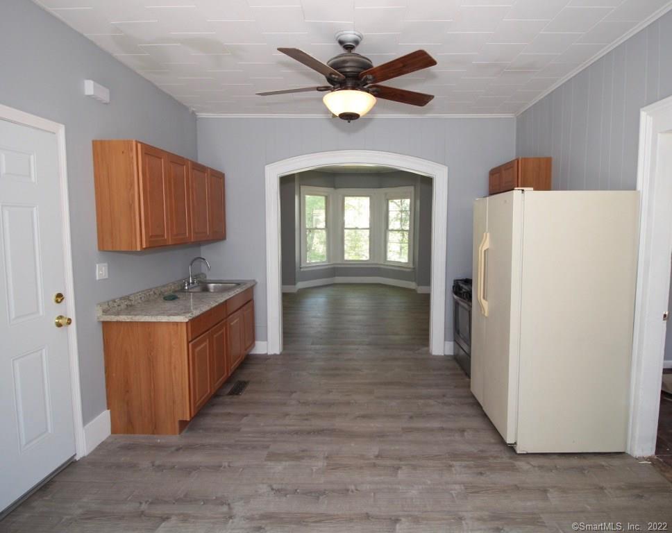 a view of a kitchen with a sink and a refrigerator