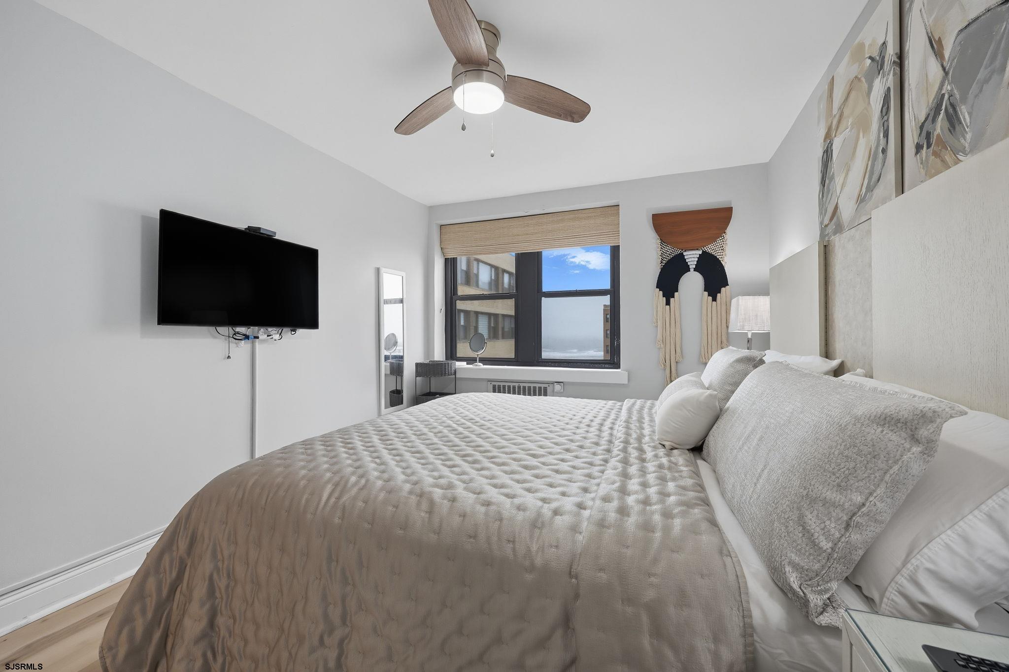 101 South Raleigh Avenue, Unit 809 Atlantic City, NJ 08401 - Photo 20 of 40 a bedroom with a bed and a flat screen tv