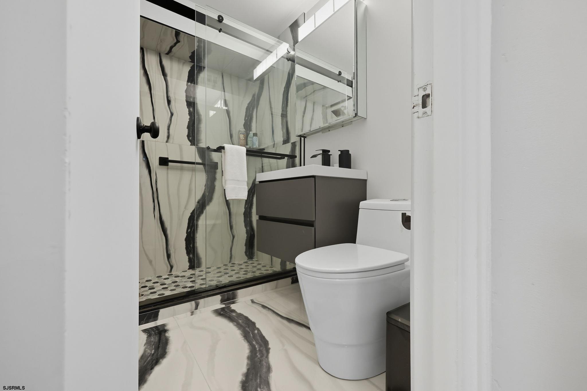 101 South Raleigh Avenue, Unit 809 Atlantic City, NJ 08401 - Photo 22 of 40 a white toilet sitting next to a bathroom sink