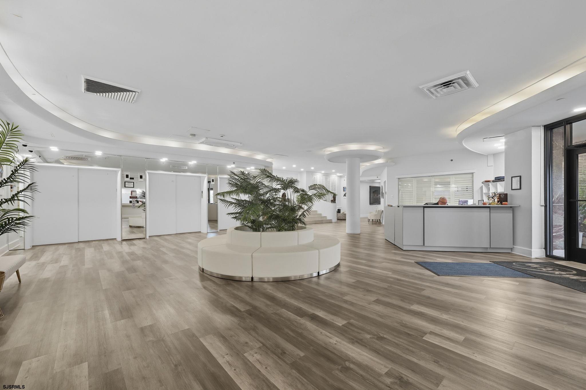 101 South Raleigh Avenue, Unit 809 Atlantic City, NJ 08401 - Photo 7 of 40 a view of a living room and kitchen with furniture and wooden floor