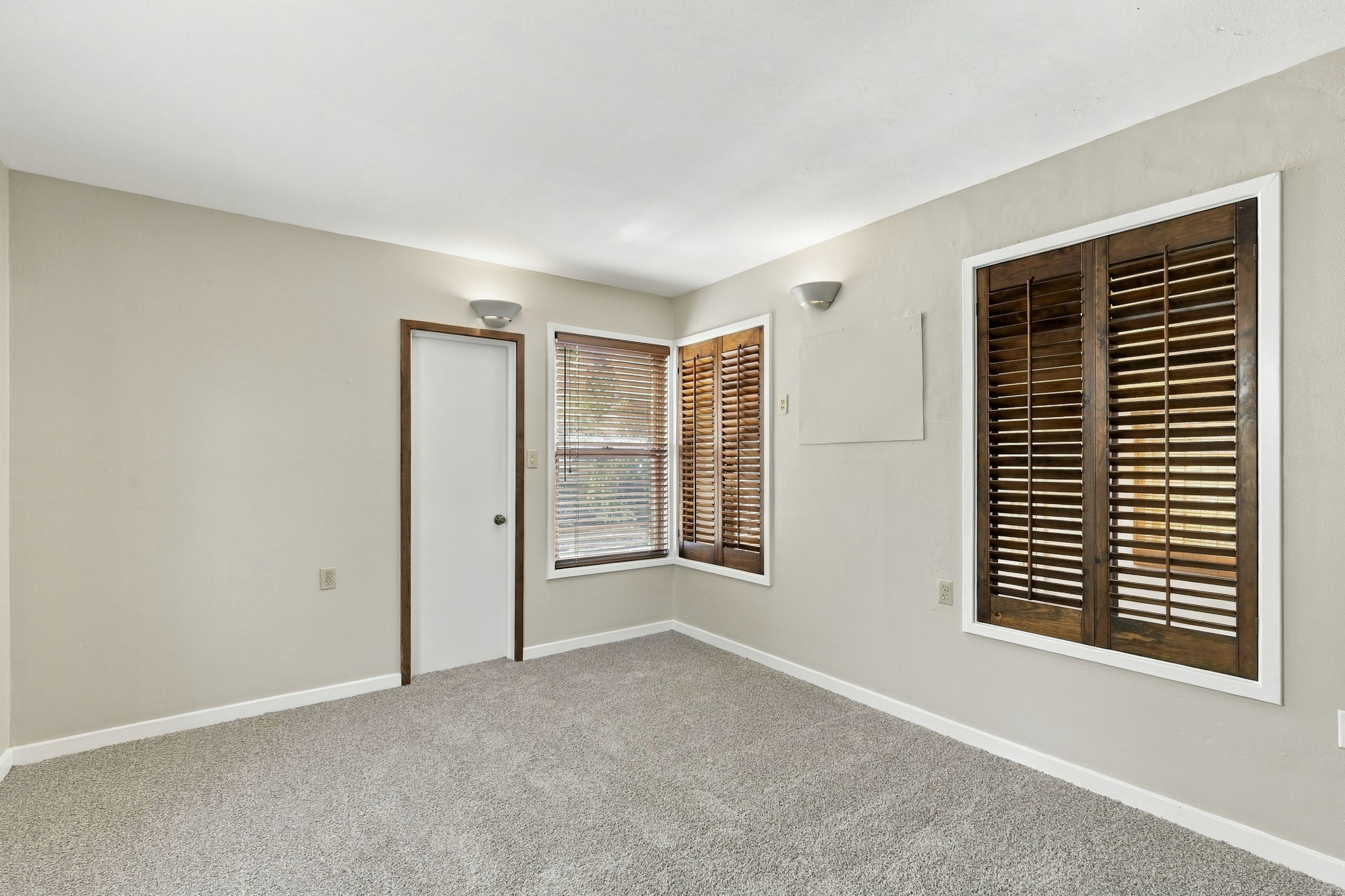 2303 Kinney Road Austin, TX 78704 - Photo 10 of 17 Rich wood shutters and textured carpeting create a warm, inviting atmosphere in this versatile room.