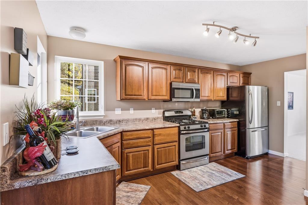 104 Broadstone Drive Mars, PA 16046 - Photo 2 of 30 a kitchen with stainless steel appliances granite countertop a sink stove refrigerator and microwave