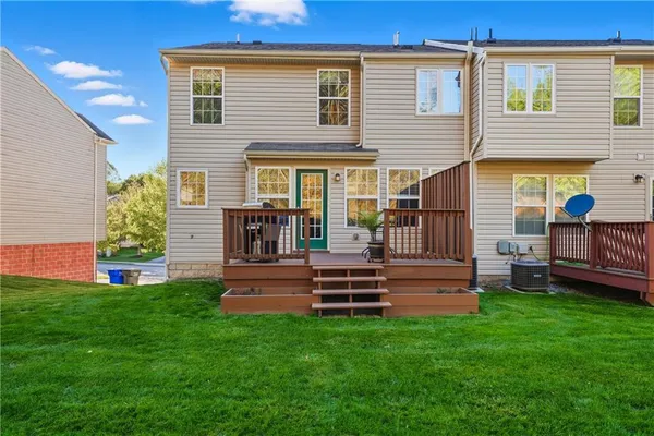 a view of a deck with a table and chairs with wooden floor and fence