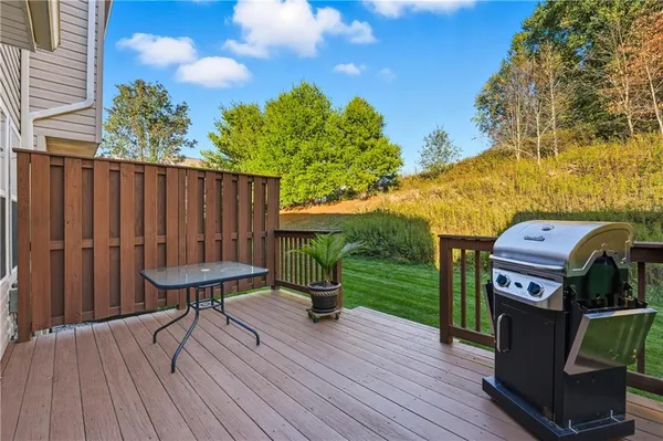 a view of a balcony with wooden floor and seating space