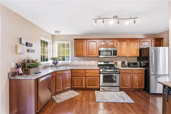 a kitchen with a sink stove and refrigerator