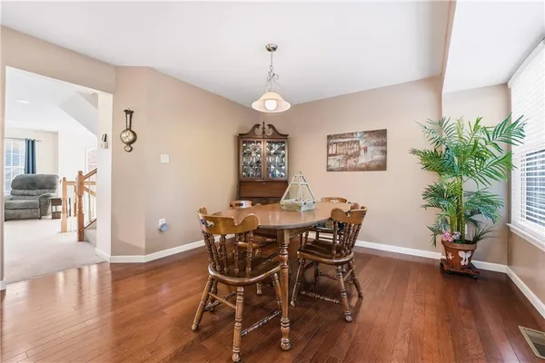 a view of a dining room with furniture wooden floor and chandelier