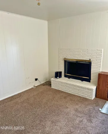 a room with a fireplace and a flat screen tv