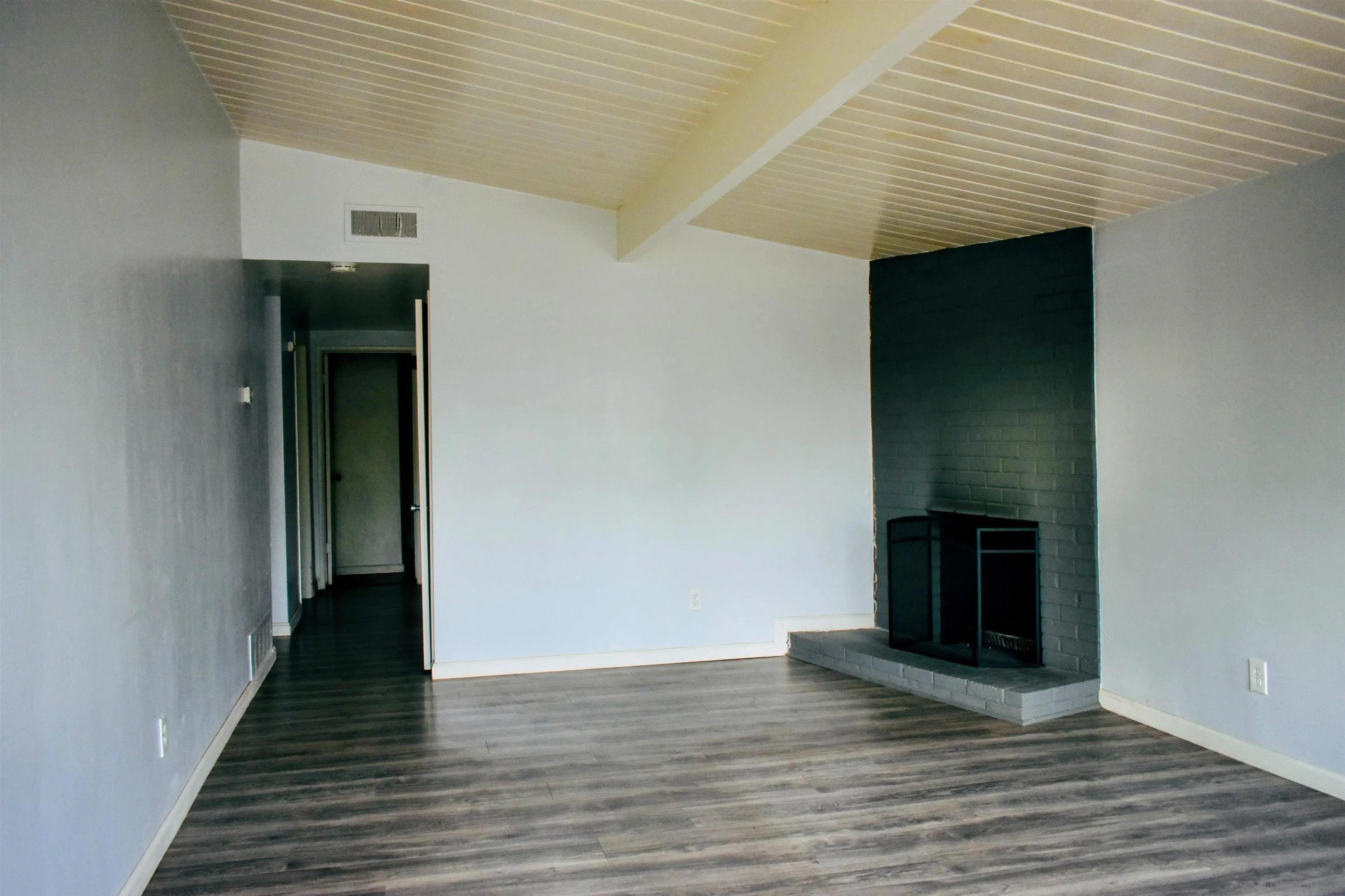 9726 Ivanho Street Spring Valley, CA 91977 - Photo 6 of 11 a view of a hallway with wooden floor and staircase