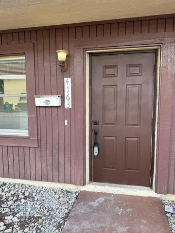 a view of a door and a wooden door